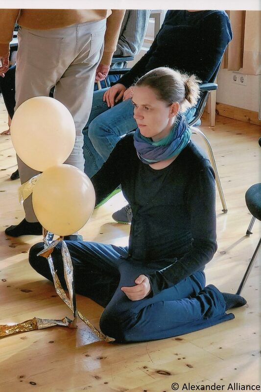 Alexandertechnik-Seminar: Teilnehmerin sitzt achtsam im Schneidersitz auf dem Boden